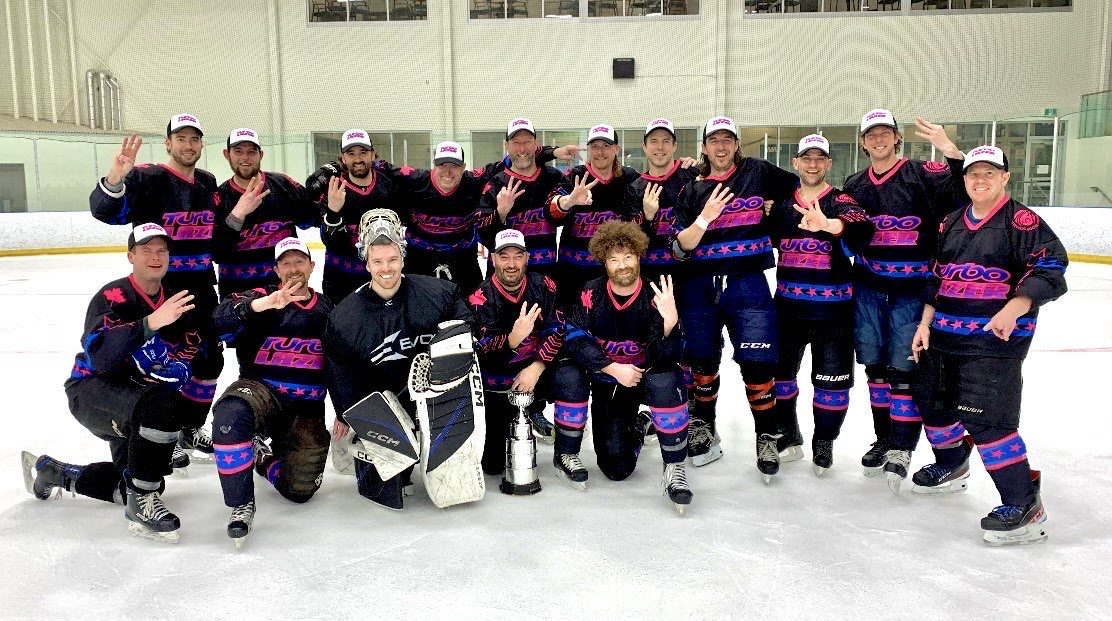 Full hockey team on the ice in matching kit, team TurboLazer sticks
