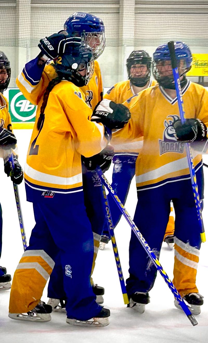 Ringette team celebrating together on the ice